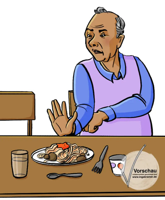 Ein Mann sitzt am Tisch und schiebt einen Teller Spaghetti von sich.