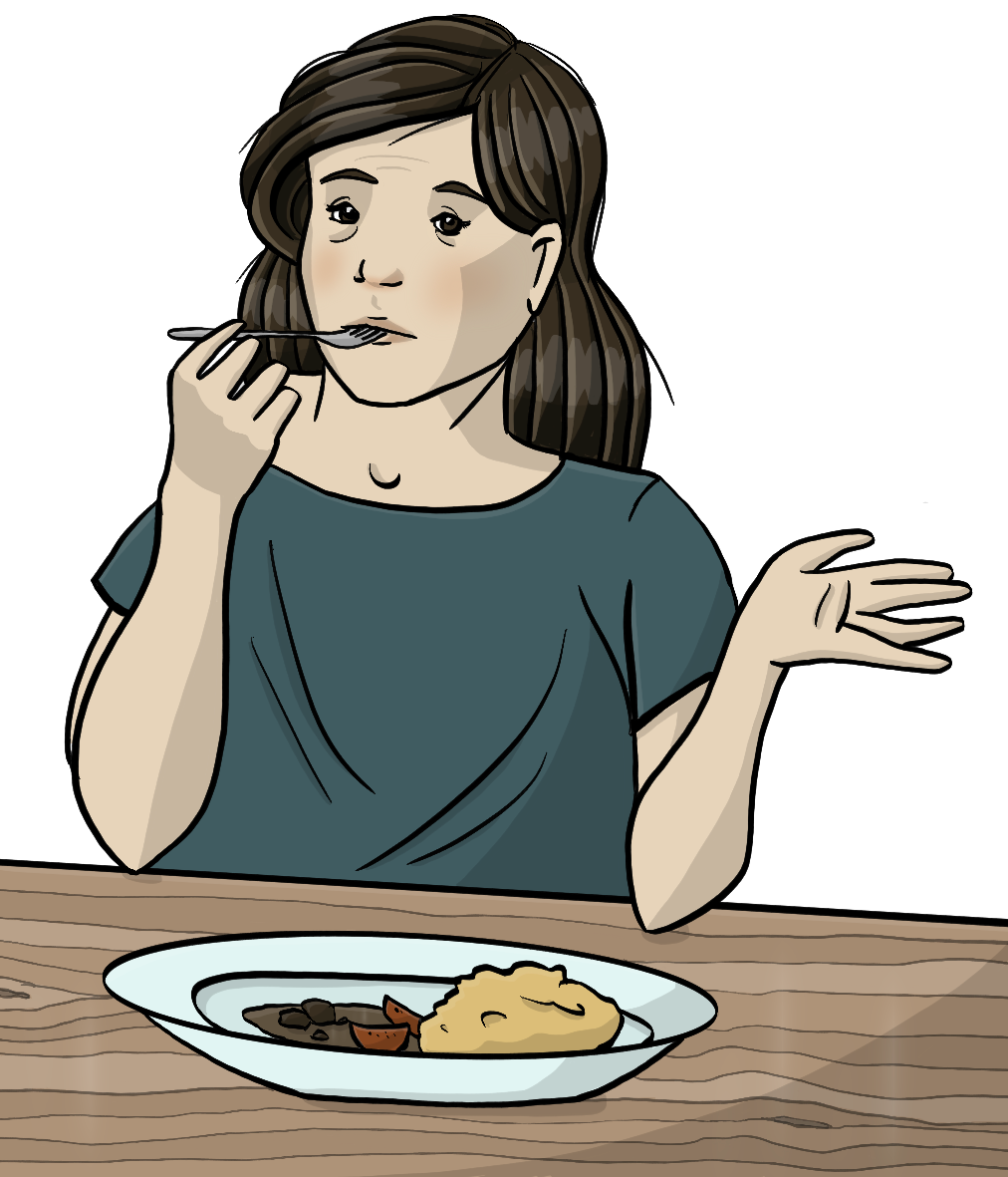 Eine Frau sitzt am Tisch. Vor ihr steht ein Teller mit Essen. Die Frau steckt eine Gabel in den Mund und hebt fragend die Hand. 