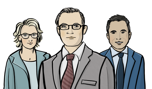Ein Mann mit Anzug und Krawatte. Hinter ihm sind eine Frau im Blazer und ein anderer Mann mit Anzug und Krawatte.