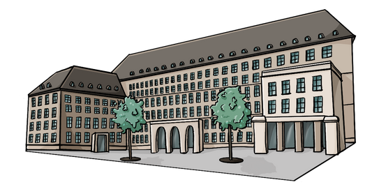 Ein langgestrecktes Gebäude mit vielen Fenstern auf einem Platz mit Bäumen.